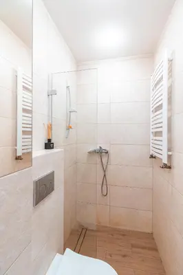 a bathroom with a shower with a glass door at Straszewskiego view in Kraków