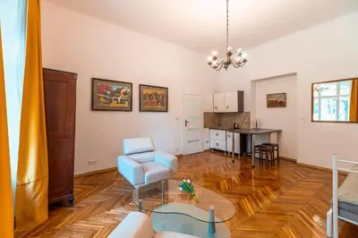 a living room with a chair and a table at Straszewskiego view in Kraków