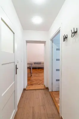 an empty hallway with a door leading to a dining room at Straszewskiego view in Kraków