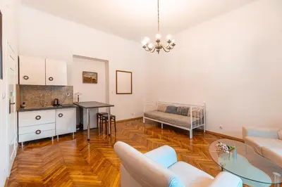 a living room with a kitchen and a dining room at Straszewskiego view in Kraków