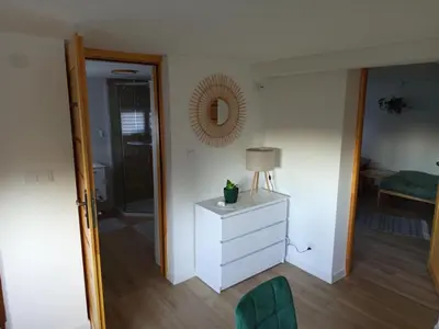 a room with a dresser and a lamp and a mirror at Apartament Gorczański Widok in Nowy Targ
