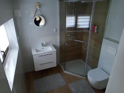 a bathroom with a shower and a toilet and a sink at Apartament Gorczański Widok in Nowy Targ