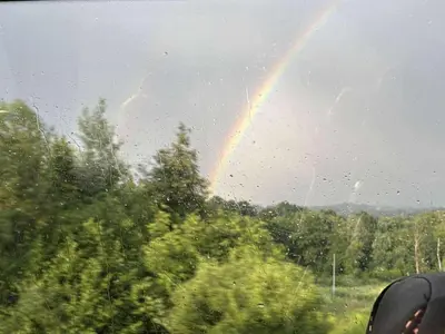 a rainbow is seen through the window of a car at Apartament Gorczański Widok in Nowy Targ