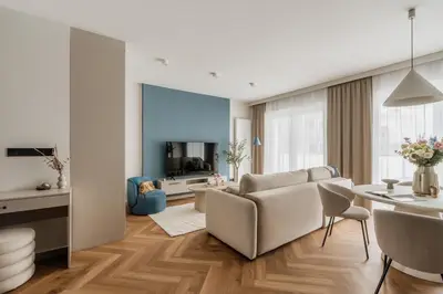 a living room with a couch and a table at Electra Apartments by StayLab in Kraków