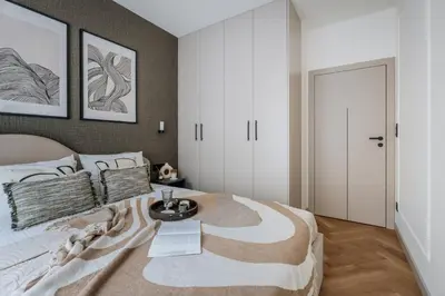 a bedroom with a large bed with a table on it at Electra Apartments by StayLab in Kraków