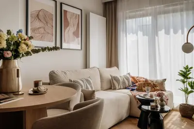 a living room with a couch and a table at Electra Apartments by StayLab in Kraków