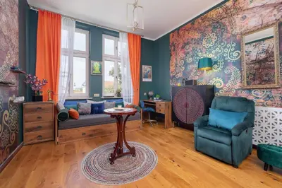a living room with a couch and a chair at Designer Apartment next to Wawel Castle by Renters Prestige in Kraków
