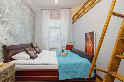 a small bedroom with a bed and a window at Designer Apartment next to Wawel Castle by Renters Prestige in Kraków