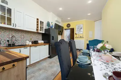 a kitchen with a table and a dining room at Designer Apartment next to Wawel Castle by Renters Prestige in Kraków