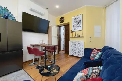 a living room with a blue couch and a table at Designer Apartment next to Wawel Castle by Renters Prestige in Kraków