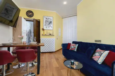 a living room with a blue couch and a table at Designer Apartment next to Wawel Castle by Renters Prestige in Kraków