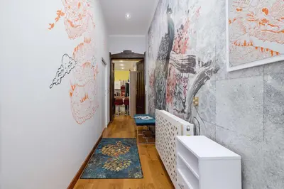 a hallway with a rug on the floor and a wall at Designer Apartment next to Wawel Castle by Renters Prestige in Kraków