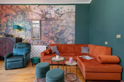 a living room with a couch and a chair at Designer Apartment next to Wawel Castle by Renters Prestige in Kraków