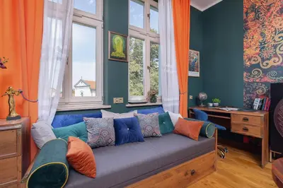a living room with a blue couch and windows at Designer Apartment next to Wawel Castle by Renters Prestige in Kraków
