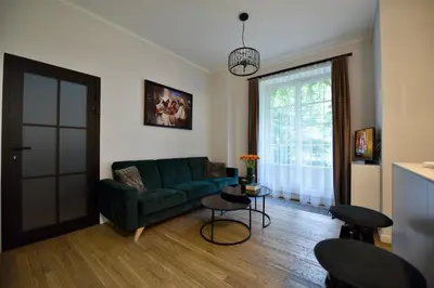 a living room with a green couch and a table at AWapartaments in Kraków