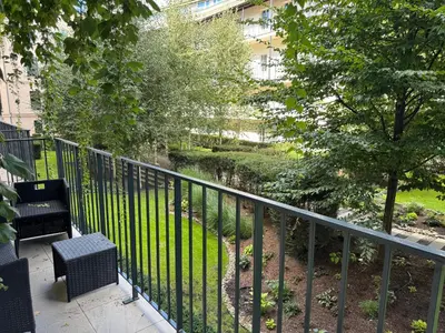 a balcony with two benches and a garden at AWapartaments in Kraków