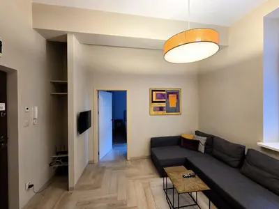 a living room with a couch and a table at Kazimierz Art in Kraków