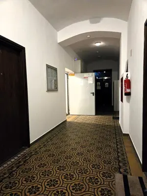 a hallway with a door and a tile floor at Kazimierz Art in Kraków
