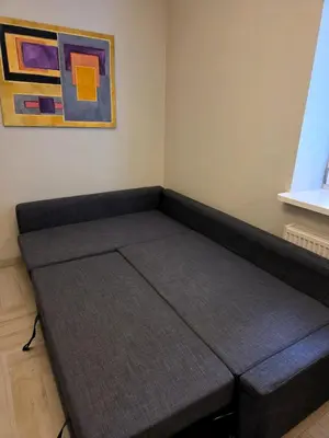 a bed in a room next to a painting at Kazimierz Art in Kraków