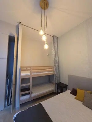 a bedroom with a bunk bed and a mirror at Kazimierz Art in Kraków