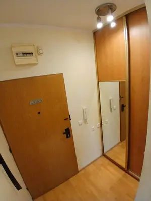 an empty room with a door and a mirror at Meadow View 10 in Kraków