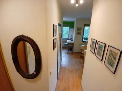 a hallway with a mirror and a dining room at Meadow View 10 in Kraków