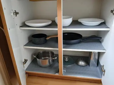 a cupboard filled with bowls and other kitchen utensils at Meadow View 10 in Kraków
