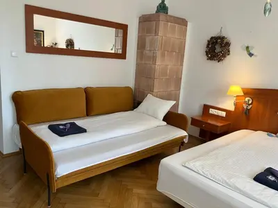 a living room with a couch and a mirror at JUBILAT - 110m2 Morawskiego in Kraków