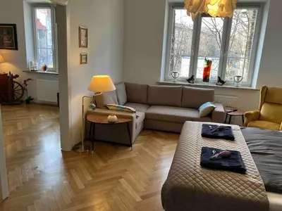a living room with a couch and a table at JUBILAT - 110m2 Morawskiego in Kraków
