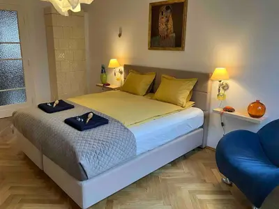 a bedroom with a large bed with two hats on it at JUBILAT - 110m2 Morawskiego in Kraków