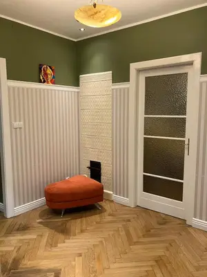 a living room with an ottoman in the corner of a room at JUBILAT - 110m2 Morawskiego in Kraków