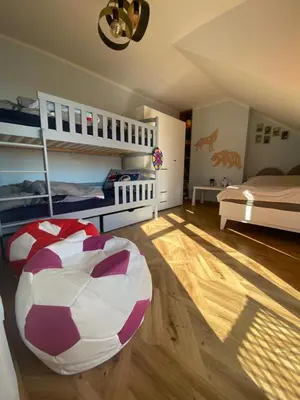 a bedroom with two bunk beds and a soccer ball on the floor at Sielsko Anielsko Apartament in Zawoja