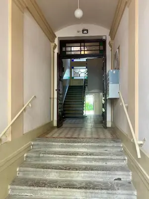 an empty hallway with stairs in a building at Family Apartment with mezzanine in Kraków