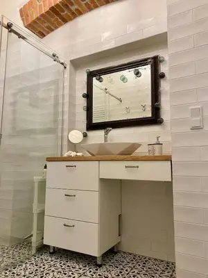 a bathroom with a sink and a mirror at Family Apartment with mezzanine in Kraków
