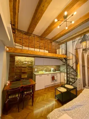 a kitchen with a loft bed and a dining room at Family Apartment with mezzanine in Kraków