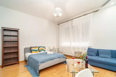 a bedroom with a bed and a couch and a table at Grzegorzki Apt - 55m2, Balcony - by Rentujemy in Kraków