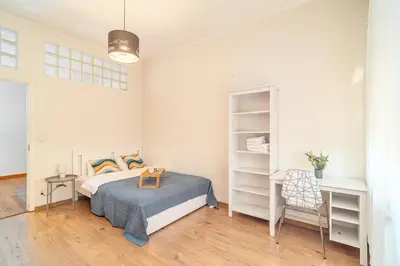 a bedroom with a bed and a desk in it at Grzegorzki Apt - 55m2, Balcony - by Rentujemy in Kraków
