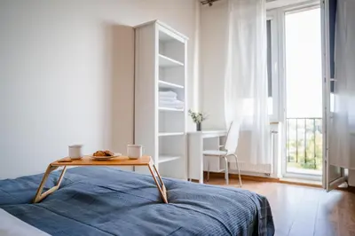 a room with a bed with a table and a desk at Grzegorzki Apt - 55m2, Balcony - by Rentujemy in Kraków