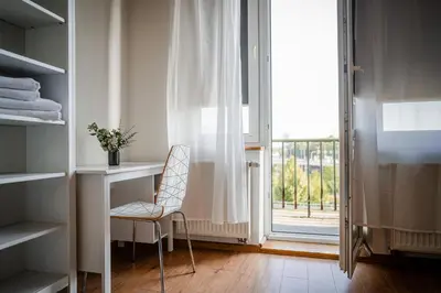 a room with a chair and a desk and a window at Grzegorzki Apt - 55m2, Balcony - by Rentujemy in Kraków