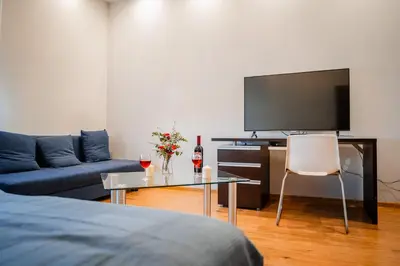 a living room with a couch and a tv at Grzegorzki Apt - 55m2, Balcony - by Rentujemy in Kraków