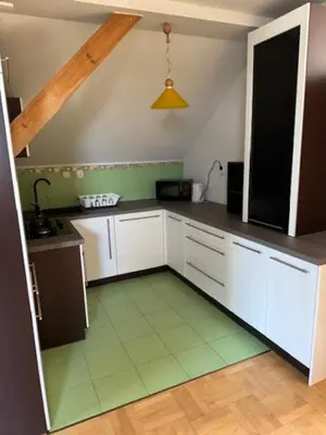 a kitchen with white cabinets and a green floor at Bochnia , nocleg,noclegi, pokoje,kwatery pracownicze in Bochnia