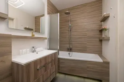 a bathroom with a tub and a sink and a shower at 6th Floor Apartment in Cracow by Noclegi Renters in Kraków