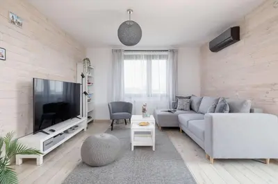 a living room with a couch and a tv at 6th Floor Apartment in Cracow by Noclegi Renters in Kraków