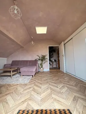 a living room with a couch and a table at Apartament pod miastem in Lanckorona
