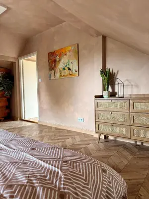 a bedroom with a bed and a dresser at Apartament pod miastem in Lanckorona