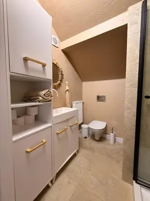 a bathroom with a toilet and a sink at Apartament pod miastem in Lanckorona