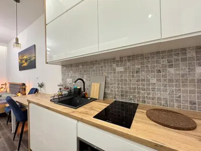 a kitchen with a sink and a counter top at Mariacki apartment in Kraków