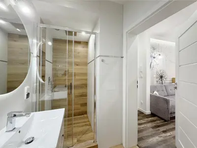a bathroom with a shower and a sink at Mariacki apartment in Kraków