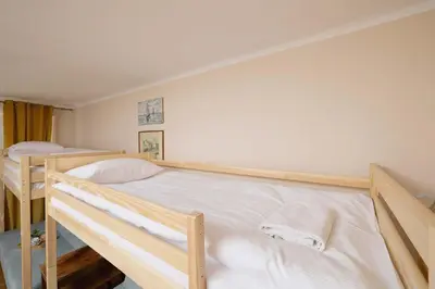 a bedroom with two bunk beds with white sheets at Nowowiejska Cosy Studio for 6 people in Cracow by Noclegi Renters in Kraków