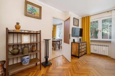 a living room with a television and a table at Nowowiejska Cosy Studio for 6 people in Cracow by Noclegi Renters in Kraków